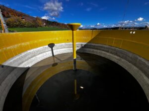 Innenansicht eines Biogasanlagen-Fermenters mit gelber Schutzbeschichtung und zentralem Rührwerksträger